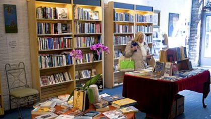 A customer browses at Awesome Books, which opened two weeks ago at 929 Liberty Ave., Downtown.