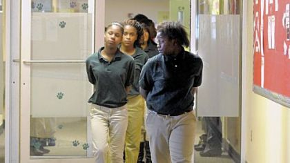 Clayton Academy seventh-graders walk to a daily afternoon assembly in single file with their hands behind their backs -- the expected norm for the school.