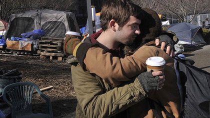 Ryan Kelley, left, of the South Side embraces Laney Trautman from the West End as some tents at the Occupy Pittsburgh camp are dismantled.