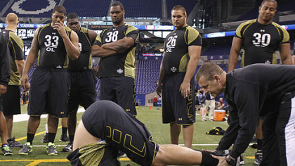 California of Pennsylvania offensive lineman Rishaw Johnson goes through a flexibility test Saturday as part of the NFL combine at Lucas Oil Stadium in Indianapolis. Johnson was invited to the combine after also being invited to play in the Senior Bowl last month.