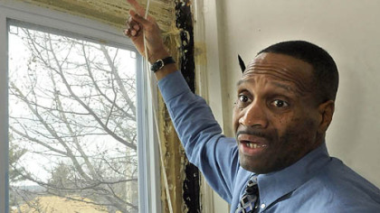 Douglas Williams' windows are a mess from excess spray insulation in an attempt to remedy severe drafts. He is one of 18 tenants who are being forced to move after their apartment building in Swissvale was condemned late last week.