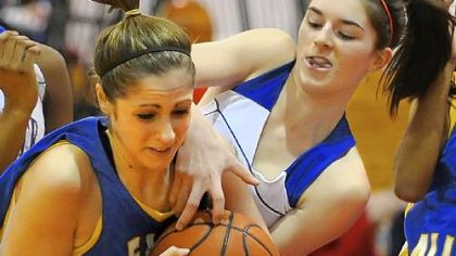 East Allegheny's Rebecca Martz, left, battles Jeannette's Monica Carl for rebound Monday. Jeannette won, 58-26.