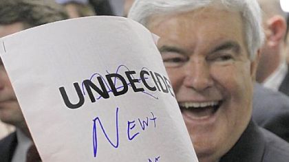 Republican presidential candidate Newt Gingrich displays an autographed sign during a campaign stop Saturday at Tommy's Country Ham House in Greenville, S.C., on South Carolina's Republican primary election day.