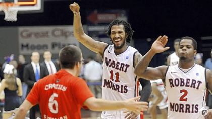 Robert Morris' Lijah Thompson, center, and Velton Jones greet fans after defeating Long Island Thursday night at the Sewall Center.