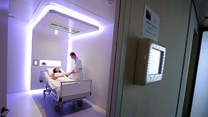 A doctor stands next to a sick woman at the Dutch Royal Philips Electronics Hospital research facility at its Eindhoven-based Research Laboratories on October 18, 2011, on the day of its inauguration.