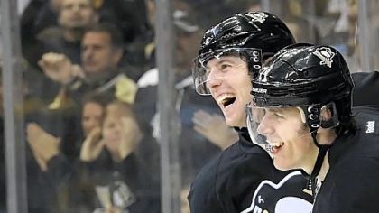 James Neal congratulates teammate Evgeni Malkin after scoring the winning goal in overtime against the Capitals Sunday at Consol Energy Center.