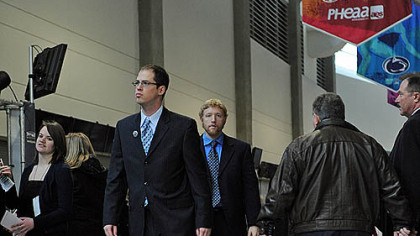 Penn State alumni Brandon Rowe, left, and Nick Wroblewski roll up their pants as they arrive the public memorial service for Joe Paterno.