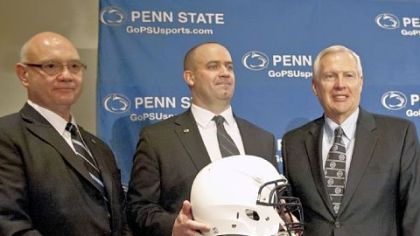Penn State's new football coach Bill O'Brien, center, poses with acting athletic director Dave Joyner, left, and university president Rodney Erickson, after he was introduced during a news conference Jan. 7 in State College.