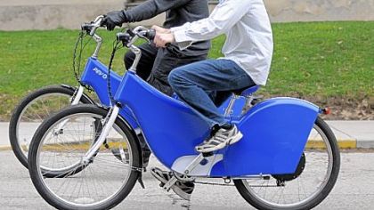 University of Pittsburgh students Thorin Tobiassen, left, and Micah Toll take their electric bikes for a ride along O'Hara Street in Oakland.