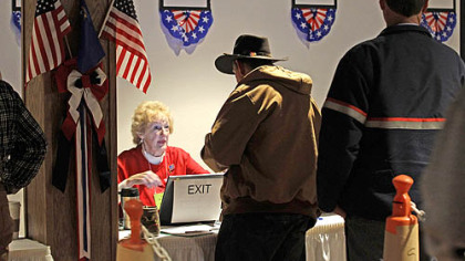 Caucus worker Carolyn Southard, left, welcomes early primary voters as they register for Nevada's Republic Caucus in Carson City County today.