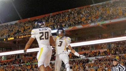 Shawne Alston, left, and Stedman Bailey celebrate Alston's 4-yard touchdown run in the Mountaineers' record-setting first half Wednesday night in Miami Gardens, Fla.