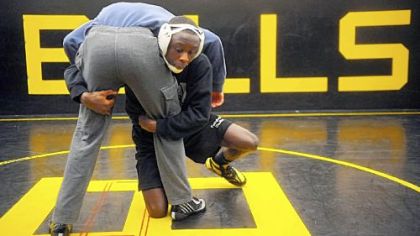 Godwin Nyama (facing camera) practices a move against Brashear teammate Doug Sauer during practice Tuesday.
