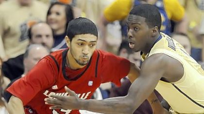 Tray Woodall, right, defends Louisville's Peyton Siva in the first half Saturday night.