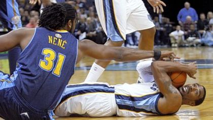 Memphis' Mike Conley, right, calls for a timeout as Denver's Nene wrestles him for the ball in the first half Tuesday night in Memphis.
