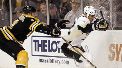 The Penguins' Richard Park, right, and Boston Bruins' Dennis Seidenberg, battle for the puck during the first period of this afternoon's game in Boston.