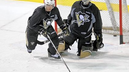 Sidney Crosby skates in front of goaltender Brent Johnson Monday at a team practice at the Bell Centre in Montreal.