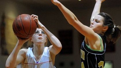 North Catholic's Courtney Wolosik goes up for a shot while being defended by Riverview's Mary Andrejko in a game earlier this season.
