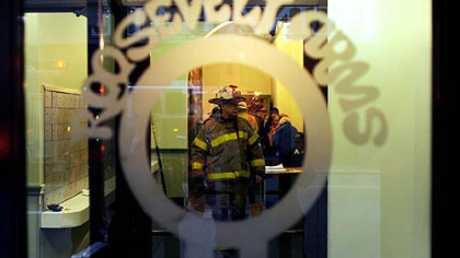 Firefighters inside the entrance of the Roosevelt Arms Apartment building on Penn Avenue, Downtown, during fire incident Thursday.