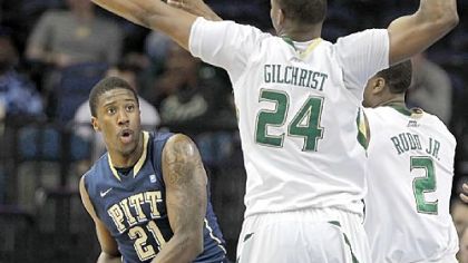 Lamar Patterson looks for a way around the defense of forward Augustus Gilchrist and forward Victor Rudd in the first half Thursday in Tampa, Fla. South Florida ended Pitt's winning streak, damaging the Panthers' efforts to make the NCAA tournament.