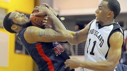 Robert Morris' Mike McFadden grabs a loose ball away from Long Island's Brandon Thompson in the first half.
