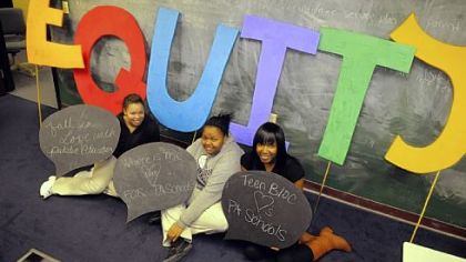 From left, Carolyn Johnson and Tia Torres, both seniors, and Dynae Shaw, a junior, all 17 and students in the TeenBloc of A+ Schools in the Hill District, sit with signs they plan to carry today in Harrisburg to protest Gov. Tom Corbett's education funding.