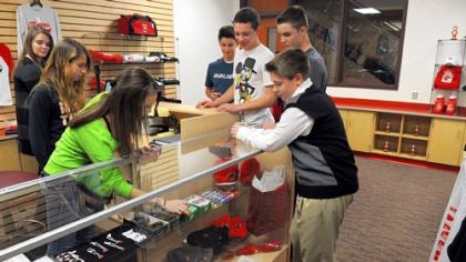 Josh Scott, right, 14, a freshman of Moon Area High School, purchases candy from Lindsay Ottaviani, 16, a junior at the school's store, on Nov. 30. Students operate the store as part of their class.