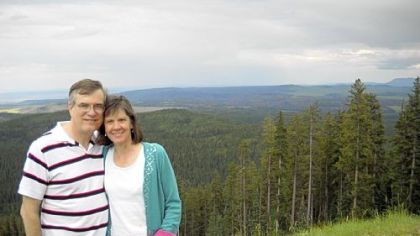 Joy and Edgar Boone with a view from Sunrise Peak on the Fort Apache reservation in Arizona.