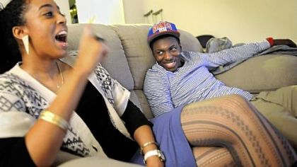 Melanie Wilmot, 22, talks about her boyfriend, Pitt point guard Tray Woodall, right, at his apartment. The day she met him, she never would have known that a decade earlier he had been selling drugs on the streets of Brooklyn.