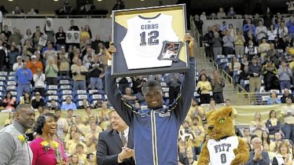 Ashton Gibbs holds up a framed jersey as he is honored on senior day Sunday night before the game against USF.
