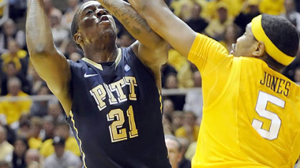 Pitt forward Lamar Patterson tries to get past West Virginia's Kevin Jones to score.