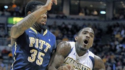 Nasir Robinson, left, tries to stop Marquette's Darius Johnson-Odom in the first half Saturday in Milwaukee. Odom had a team-high 18 points in the Golden Eagles' 62-57 win.