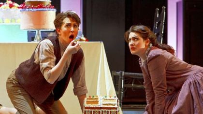 Stephanie Lauricella, left, as Hansel and Suzanne 
Vinnik as Gretel happen upon the witch's cottage and try a bite of a gingerbread house in Pittsburgh Opera's "Hansel & Gretel."