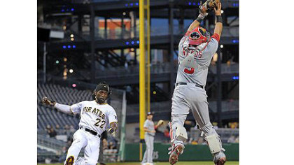 Pirates' Andrew McCutchen scores past Nationals catcher Wilson Ramos.