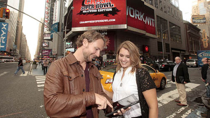 Last year's  Doritos "Crash The Super Bowl" winners J.R. Burningham, left, and Tess Ortbals kick off this year's contest in Times Square, Sept. 26 in New York.
