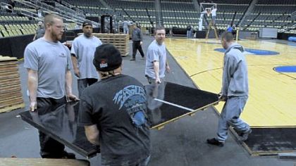 Workers at Consol Energy Center convert the floor to a basketball court for this weekend's NCAA men's basketball tournament.