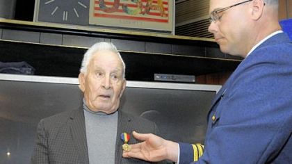 Coast Guard Cmdr. Richard Timme, right, presents the Navy and Marine Corps Medal to Thomas A. Vitale, 90, at the American Legion hall in Belle Vernon on Friday.