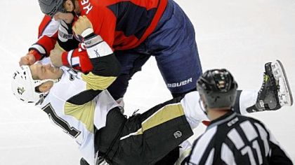 Washington's Matt Hendricks, top, gets the better of Craig Adams in the first period Wednesday in Washington.