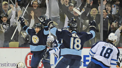 The Penguins' Kris Letang celebrates after scoring a goal against the Winnipeg Jets at the Consol Energy Center in this afternoon's game.