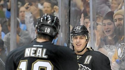 Evgeni Malkin, right, celebrates his tying goal in the first period with James Neal. Malkin added a goal in the shootout.