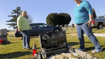 Jamie Stickle's mother, Margie Walls (left), and stepmother, Judy Stickle, visit her grave at Park Place Cemetery in Uniontown.