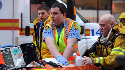 Paramedics perform CPR on a man who was found inside the Roosevelt Arms building on Penn Avenue in Downtown Pittsburgh after a fire broke out on the 9th floor of the building.