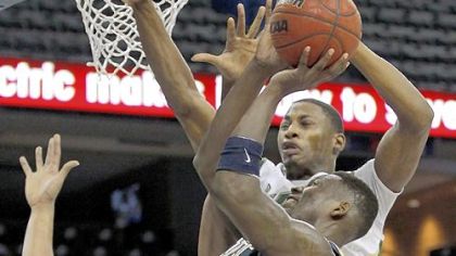 South Florida guard Hugh Robertson blocks Talib Zanna's shot in the second half Wednesday in Pitt's loss.