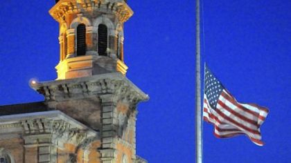 The flag flies at half-staff outside the Geauga County, Ohio,  Courthouse in Chardon Monday evening.