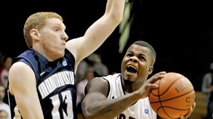 Robert Morris' Velton Jones drives to the basket against Monmouth's Andrew Nicholas in the second half of the NEC conference quarterfinals Thursday night at the Sewall Center.