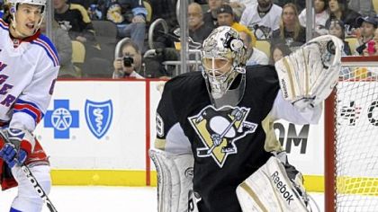 Marc-Andre Fleury gloves one of his 27 saves en route to his franchise record-tying 22nd career shutout in the Penguins' 2-0 win vs. the New York Rangers.