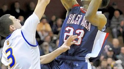 Shaler's Geno Thorpe drives to the net against Lincoln Park's Trey Hosack Sunday. Thorpe leads the Titans with 22.8 points per game and is committed to play for Penn State.