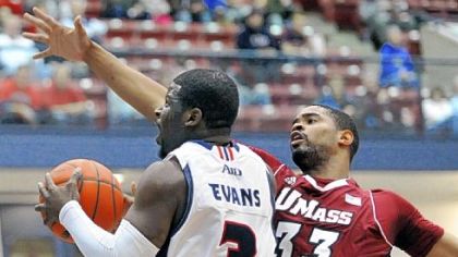 Duquesne's Eric Evans, left, works his way past Terrell Vinson of Massachusetts.
