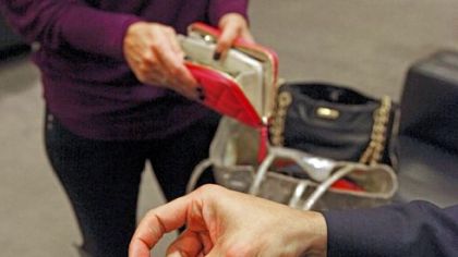 A Nordstrom employee uses a mobile device for a payment at the flagship store in December in downtown Seattle. The company is working on new mobile-payment options.