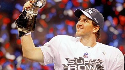 New York Giants quarterback Eli Manning  of the poses with the Vince Lombardi Trophy after the Giants defeated the Patriots by a score of 21-17 in Super Bowl XLVI.