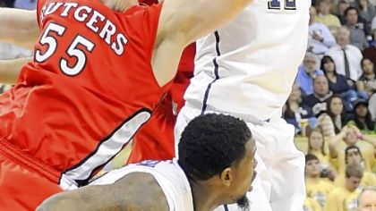 Talib Zanna, right, gets tied up with Rutgers' Gilvydas Biruta going for a rebound in the second half of Pitt's 62-39 loss to the Scarlet Knights at Petersen Events Center.